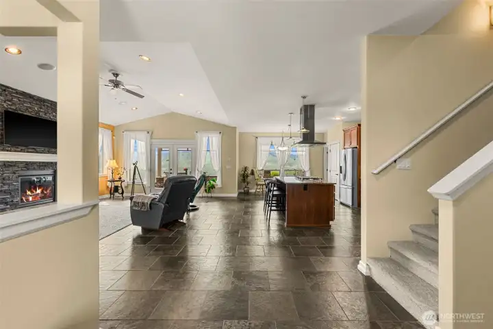 Lovely stone fireplace surround w/ a cozy focus