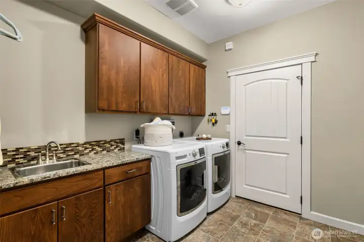 Spacious 3 car garage with shop space as well! Storage units stay.