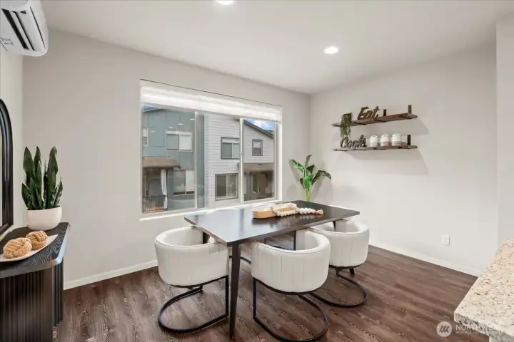 Dining Area with window views and space for a full dining set. Positioned adjacent to the kitchen for convenience.