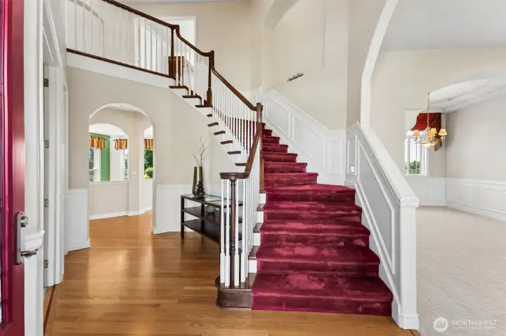 Stunning entry with vaulted ceilings and a sweeping staircase
