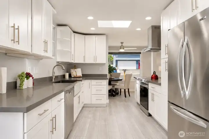 Kitchen – Updated kitchen with white cabinets, stainless appliances, and modern finishes Kitchen – Updated kitchen with white cabinets, stainless appliances, and modern finishes
