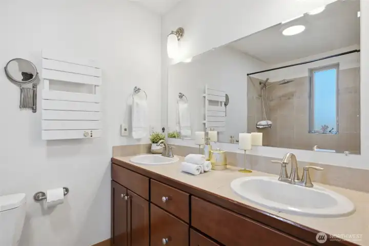 Heated floor and towel rack in luxurious primary bathroom Heated floor and towel rack in luxurious primary bathroom