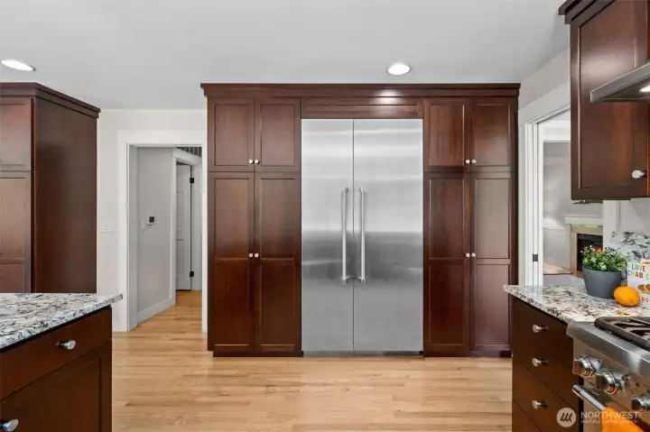 Floor-to-ceiling smooth-wood cabinetry surrounds the built-in Thermador refrigerator, creating a polished, custom look with exceptional storage and pull out shelves. Feeling like changing it up? These cabinets could easily be painted!