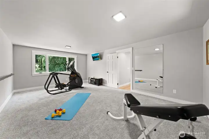 The rec room/bonus room upstairs features plush carpet, a wide-open space... a perfect place to be loud and boisterous while the lower level stays tranquil.