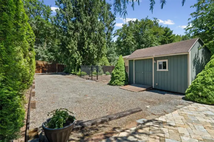 With a separate entrance from the street, you'll find  this expansive gravel parking area with approved permits in place for a 25' x 32' RV garage shop, offering exciting potential for any dream to come true!