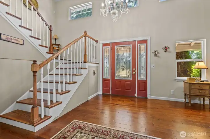 Main Entry with 2-Story Vaulted Ceilings and Custom Staircase.