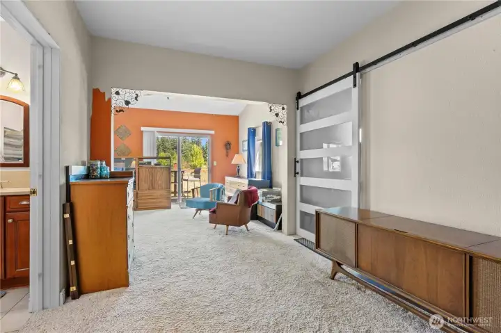 Entry into Massive 600sqft Primary Bedroom Suite. On Right: Walk-In Closet w/Sliding Barn Door. On Left: En Suite Full Bath