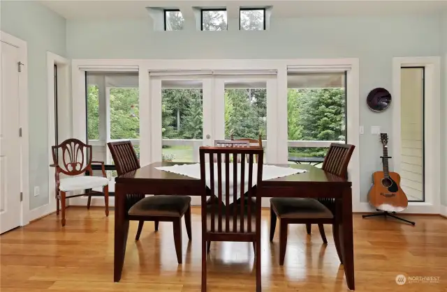 Open the French doors off the dining room, and be greeted by a deck overlooking the serene yard, a perfect spot for enjoying the gentle breeze and captivating views.