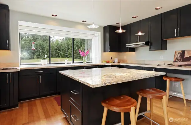 Hand-crafted soft-close cabinets and modern appliances complement this kitchen.
