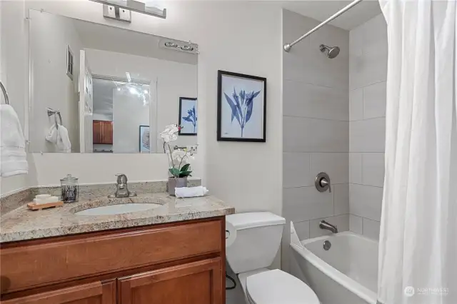Nicely updated full bathroom includes a recently retiled shower with Italian porcelain.