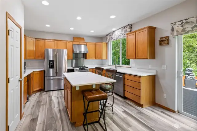 Beautifully updated Kitchen lookig out to the private backyard, greenbelt! Featuring Ceramic-Porcelain Flooring tile that spills into the Family rm as well!