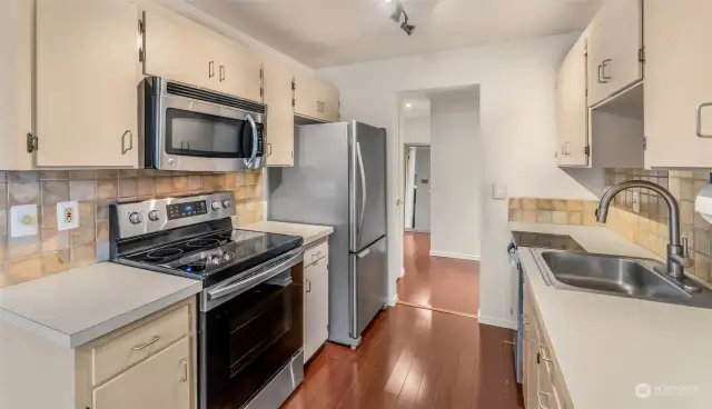 Galley Kitchen with stainless steel appliances