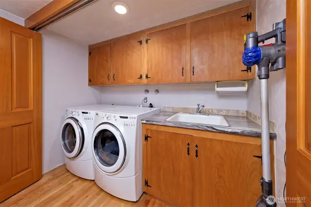 The utility area with a sink is behind the beautiful doors in the dining room area.