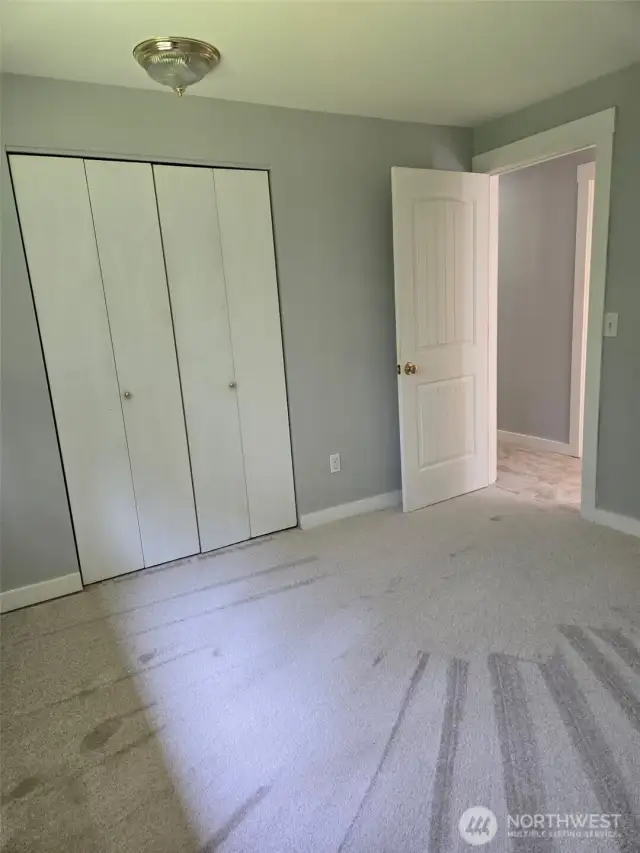 This cozy bedroom features fresh neutral paint, plush carpet, and a large closet—ready for move-in and easily styled to suit your taste.