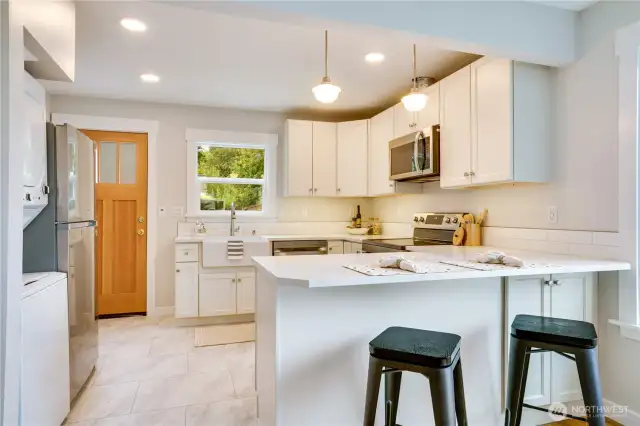 This stunning contemporary kitchen is the heart of the home—beautifully updated to complement the timeless charm of this storybook cottage.