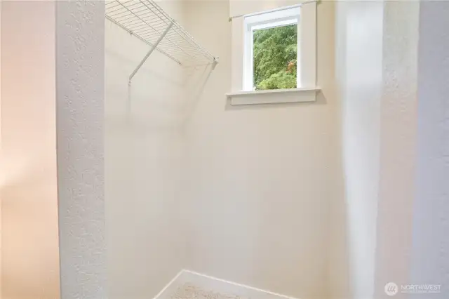 Even the closet gets a dose of sunshine—thanks to a thoughtfully placed window that brings in natural light.