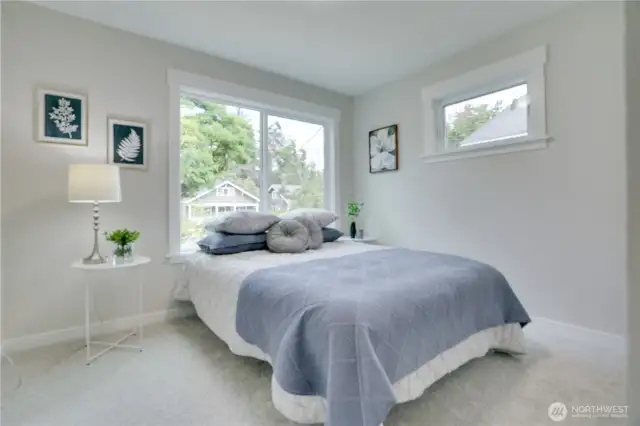 The second bedroom boasts fresh carpet, new elevated millwork, and sunny windows that offer and soft natural light making this a perfect retreat.