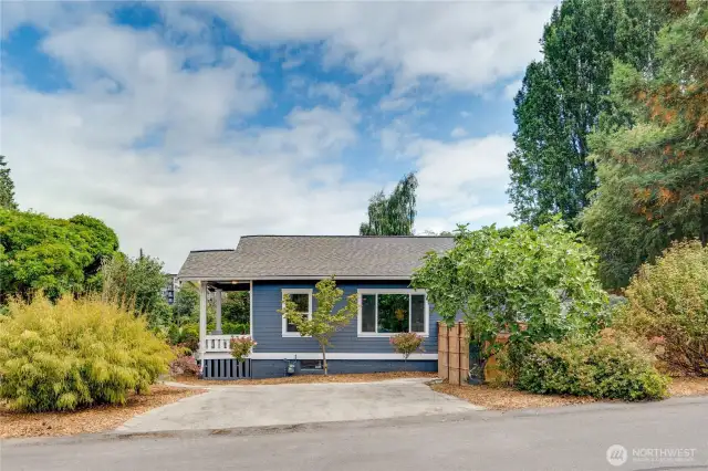 Enjoy the convenience of private parking for two, nestled among the trees and bushes in your beautifully landscaped yard and just steps from your front and back porch.