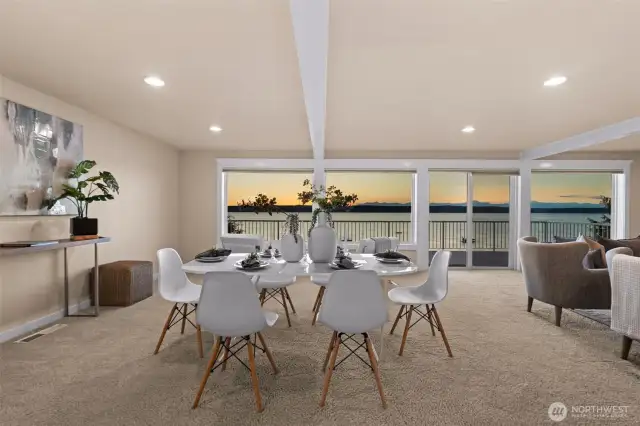 An open and airy main floor complete with powder bath, laundry, kitchen with dining space, and living room.