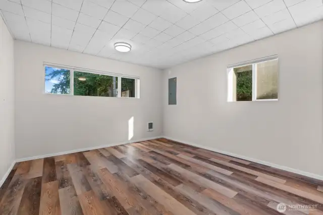 Spacious bedroom filled with natural light from abundant windows.