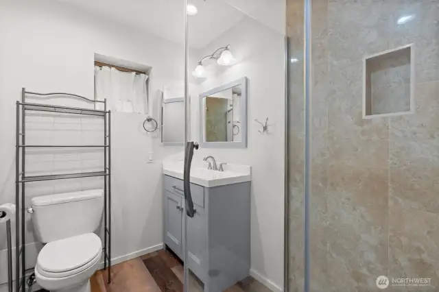 A refreshed 3/4 bath tucked at the hall’s end for added privacy.