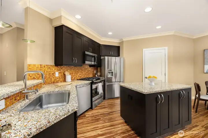 Plenty of kitchen storage with the custom cabinetry, island & pantry.