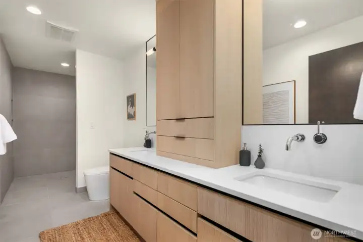 Primary Bathroom with Dual Sinks and Ample Storage Cabinets.