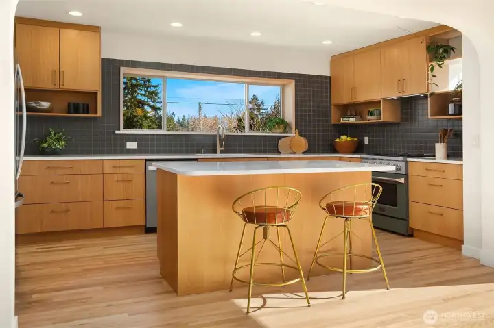 Designer kitchen with custom rift oak cabinetry & island seating.