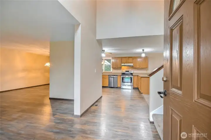Front door opens to  kitchen, dining room and living room with recent updated flooring