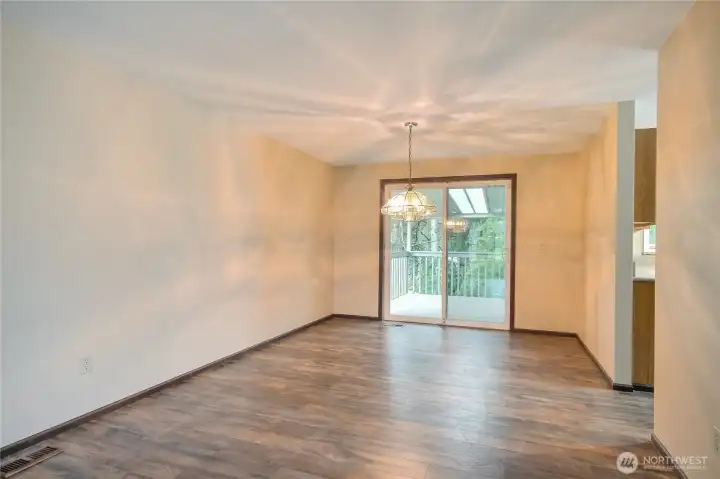 Dining room facing deck with kitchen off to the right