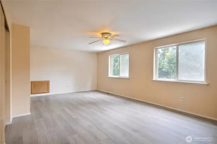 Spacious primary bedroom highlighting luxury vinyl flooring