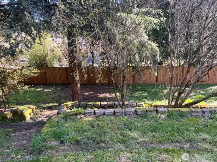 Fully fenced backyard with path to lower levels
