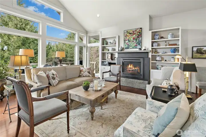 The spacious and light filled living area has built ins, vaulted ceilings and a stunning stone fireplace.