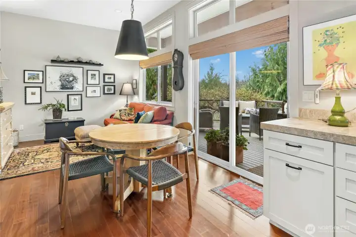 The every day eating area is quaint with sliding glass doors to the deck and a cozy sitting area.