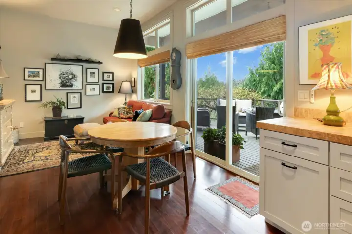 he every day eating area is quaint with sliding glass doors to the deck and a cozy sitting area.