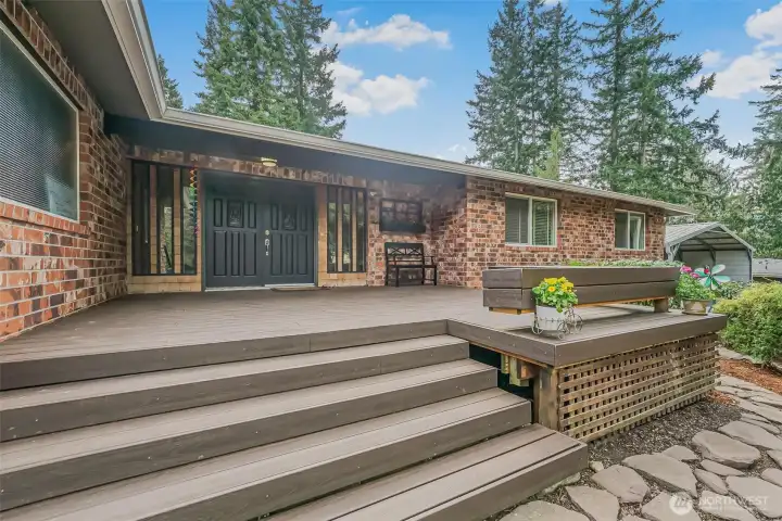 Entry features a spacious front porch that beautifully showcases the home’s classic brick exterior.