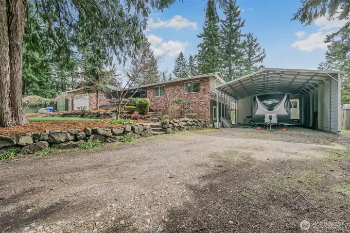 Large covered RV parking provides ideal space for recreational vehicles, boats, or additional storage.