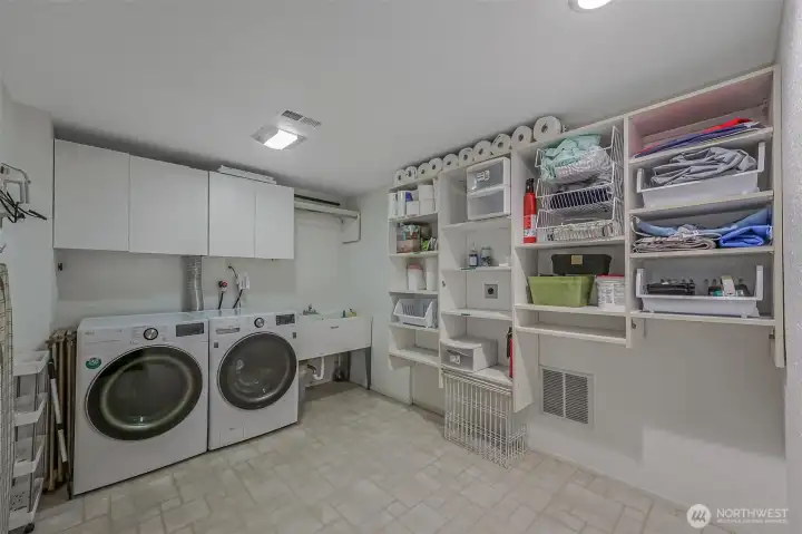 Large dedicated laundry area with storage for everyday convenience.