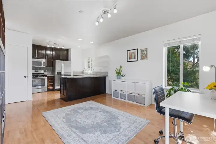 View from the family room towards the kitchen. Kitchen pantry door located on the left side of the photo.