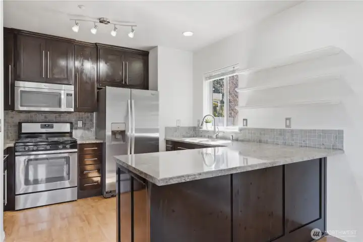 This fairly recently renovated eat-in kitchen is elegant and well appointed with beautiful countertops, cabinetry (freshly oiled to help preserve the wood), and stainless steel appliances.