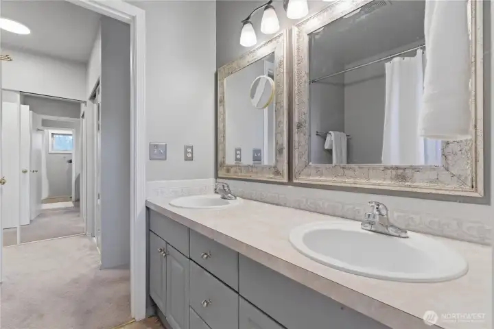 View from the primary bathroom into the primary bedroom hall and closet area.