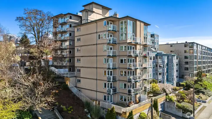 Built in 2003, the Highmark Condominium consists of 19 residences (two buildings connected by a breezeway). Unit #201 is a corner unit on the second floor of the west building. The parking garage entrance is accessed via Melrose Ave, which is where this photo was taken from.