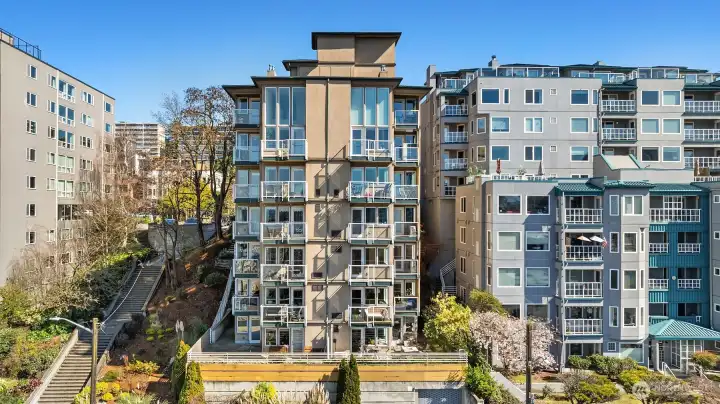 Built in 2003, the Highmark Condominium consists of 19 residences (two buildings connected by a breezeway). Unit #201 is a corner unit on the second floor of the west building. The parking garage entrance is accessed via Melrose Ave, which is where this photo was taken from.