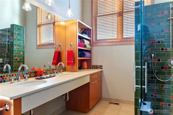 The bathroom has lots of natural light, two sinks and a large walk-in shower.