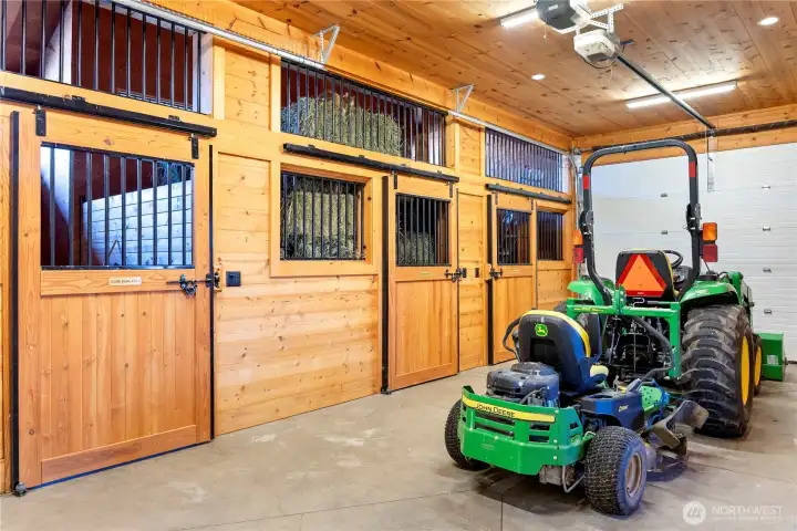 At one end of the garage are three fitted horse stalls, room for farming equipment, grooming station and a tack room.