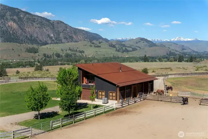 The property includes several corrals with three rail wood fencing.