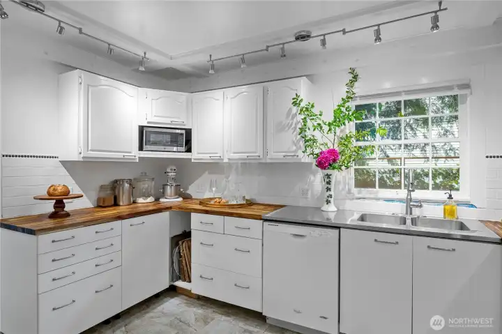 Completely updated kitchen countertops highlighted by rich, solid butcher block surfaces.