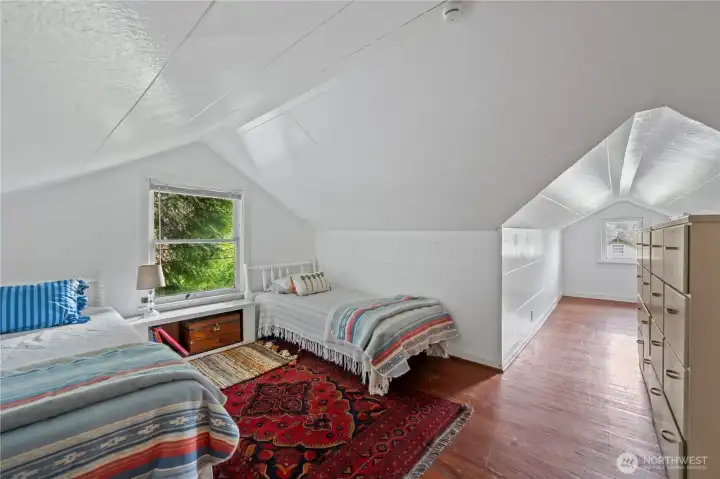 Third bedroom situated on the upper floor with cozy alcoves and natural light.