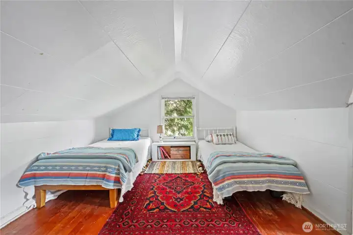 Second story bedroom, tucked away into eaves with lots of storage options