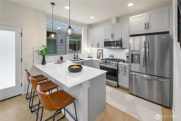 Quartz countertops and nice stainless steel appliances.